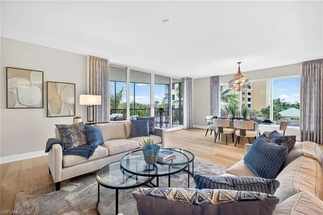 a living room with furniture and a floor to ceiling window