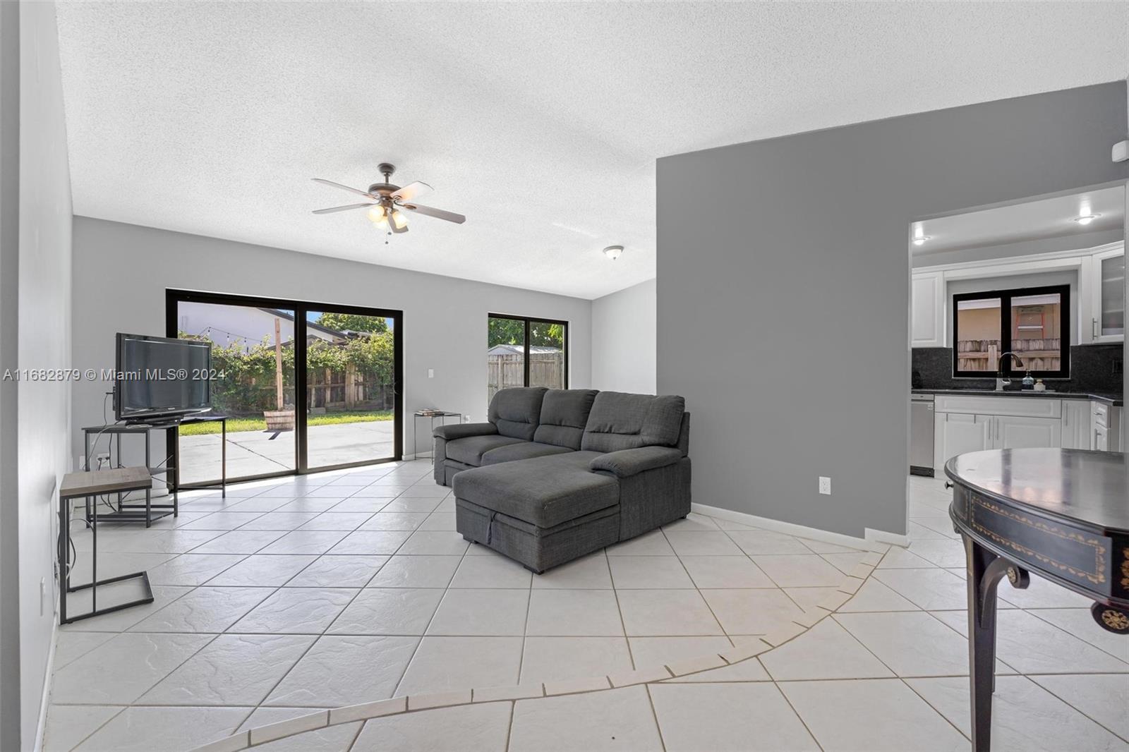 14006 Southwest 48th Terrace Miami, FL 33175 - Photo 22 of 24 a living room with furniture and a flat screen tv