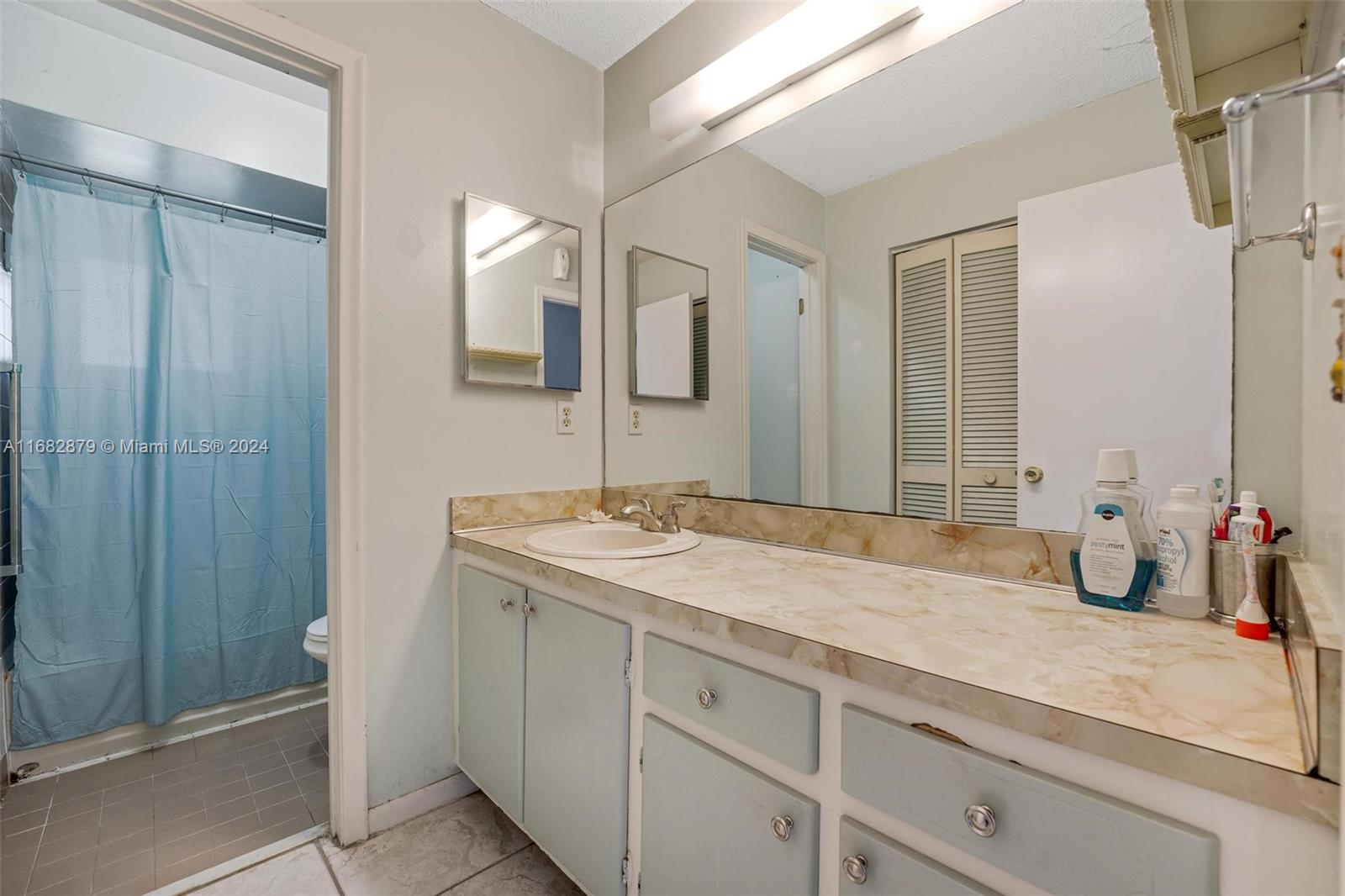 14006 Southwest 48th Terrace Miami, FL 33175 - Photo 9 of 24 a bathroom with a sink and a mirror