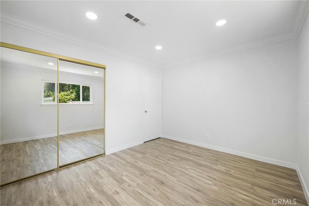 575 Winona Way Pasadena, CA 91103 - Photo 17 of 29 an empty room with wooden floor and door