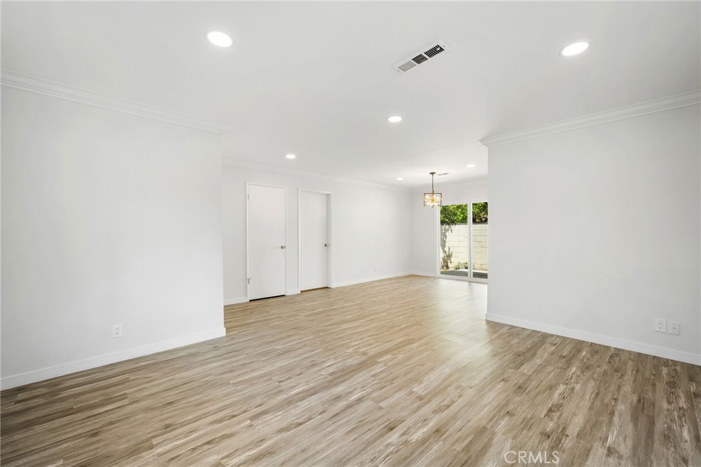 575 Winona Way Pasadena, CA 91103 - Photo 6 of 29 an empty room with wooden floor and windows