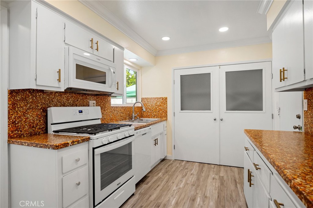 575 Winona Way Pasadena, CA 91103 - Photo 10 of 29 a kitchen with stainless steel appliances granite countertop a stove and a sink