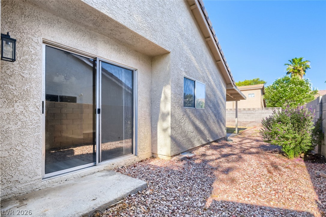 2343 Valleywood Road Henderson, NV 89014 - Photo 25 of 29 A private backyard retreat featuring a sliding glass door and low-maintenance landscaping.