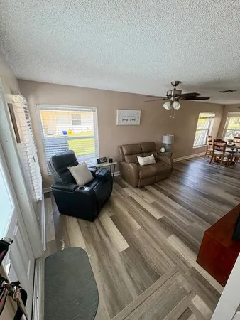 a living room with furniture and a chandelier