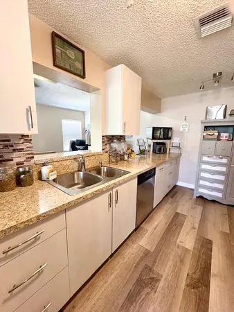 a kitchen with a sink stove and cabinets