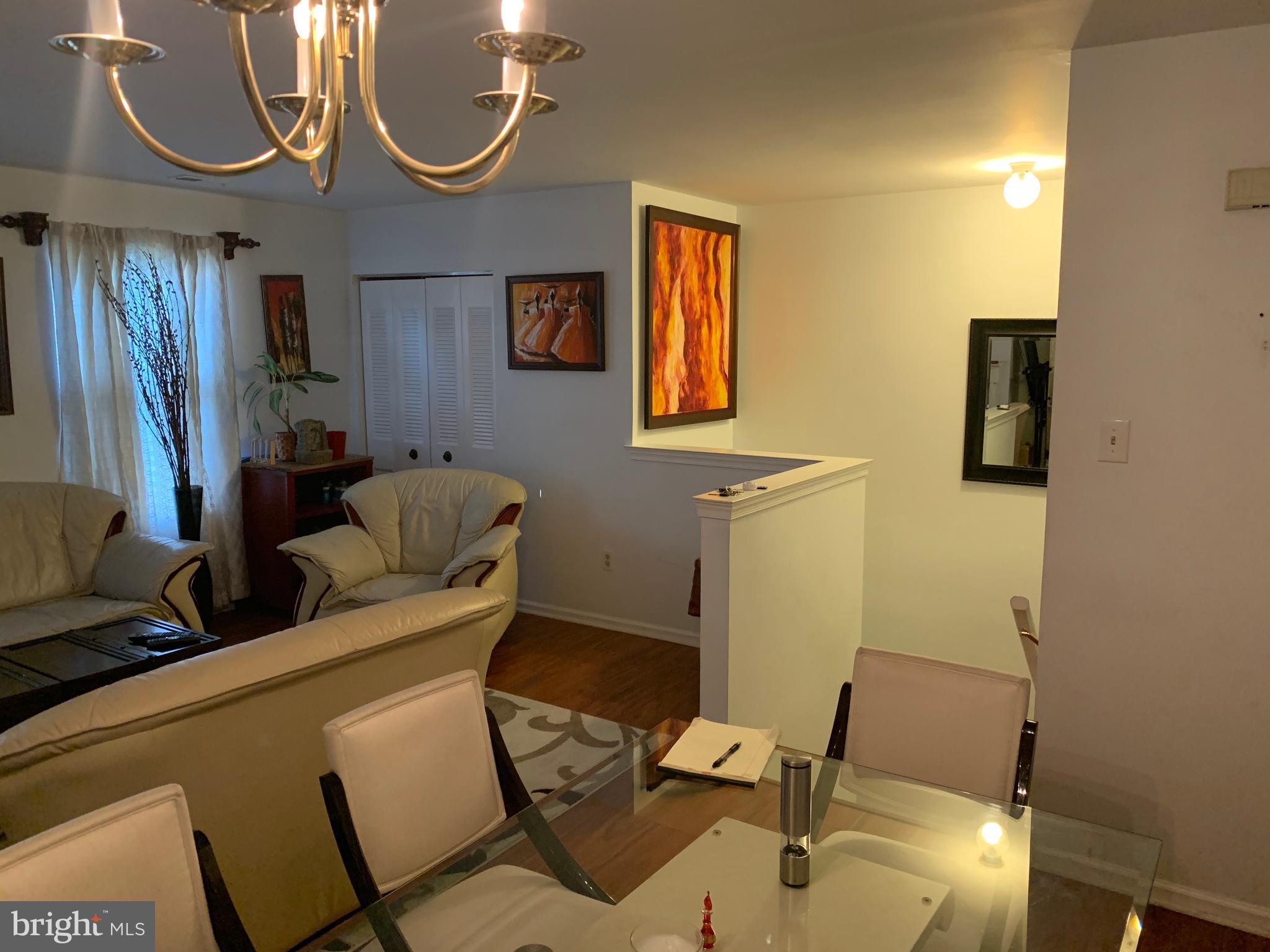 1609 Huntingdon Mews Clementon, NJ 08021 - Photo 5 of 15 a living room with furniture a flat screen tv and a window