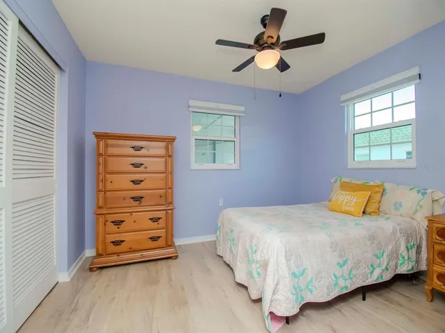 a bedroom with a bed a window and a chandelier