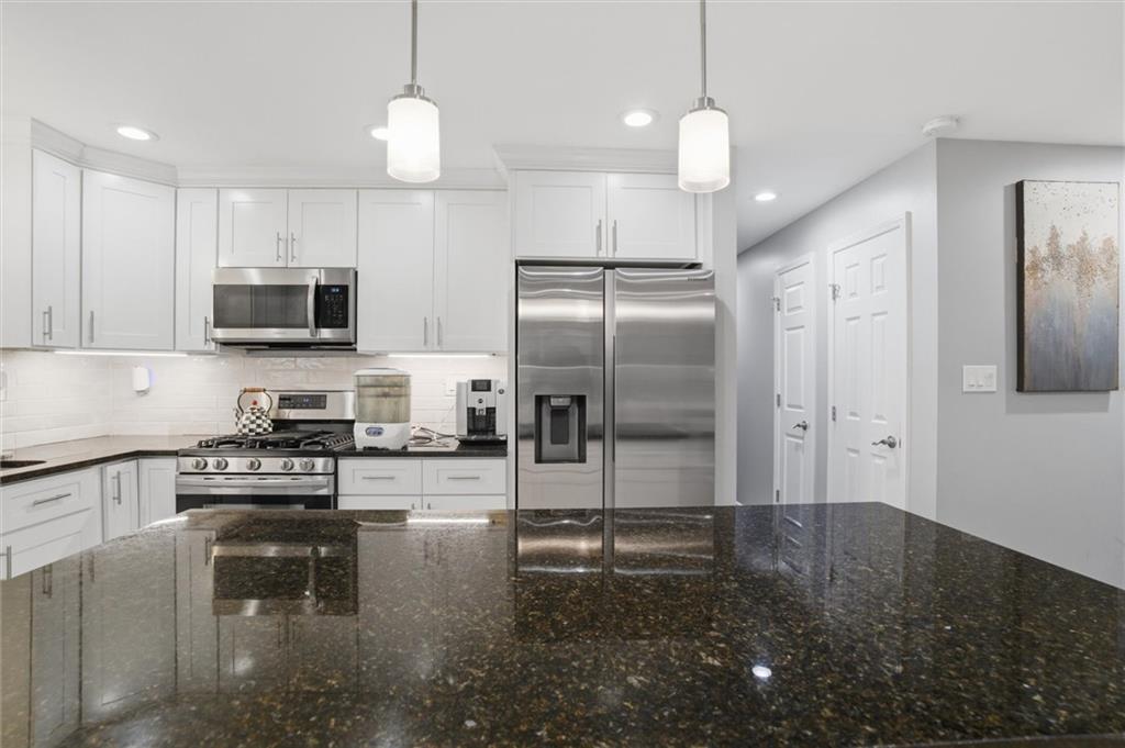 103 Tree View Drive Coraopolis, PA 15108 - Photo 14 of 48 a kitchen with granite countertop a refrigerator a stove a microwave and island