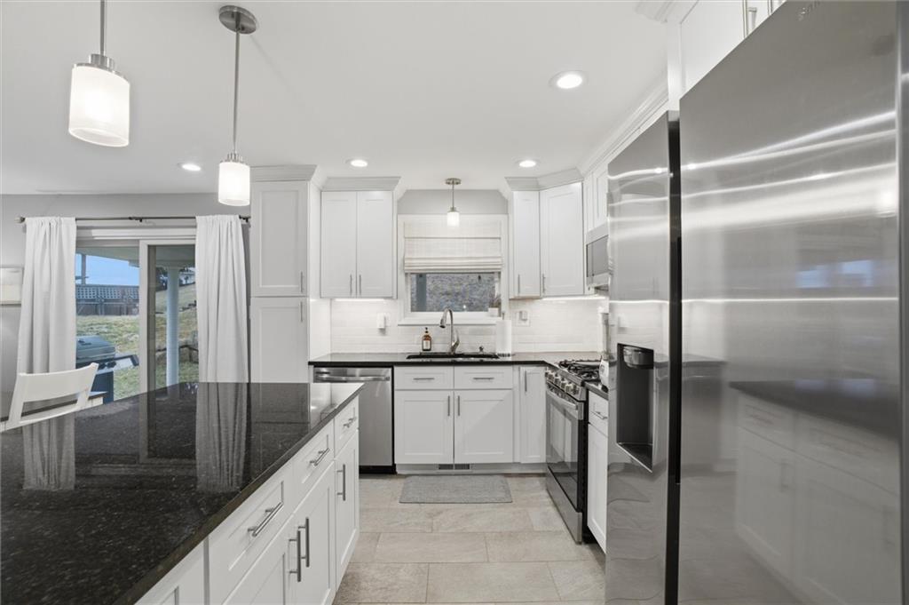 103 Tree View Drive Coraopolis, PA 15108 - Photo 15 of 48 a kitchen with stainless steel appliances granite countertop a sink a stove and a refrigerator