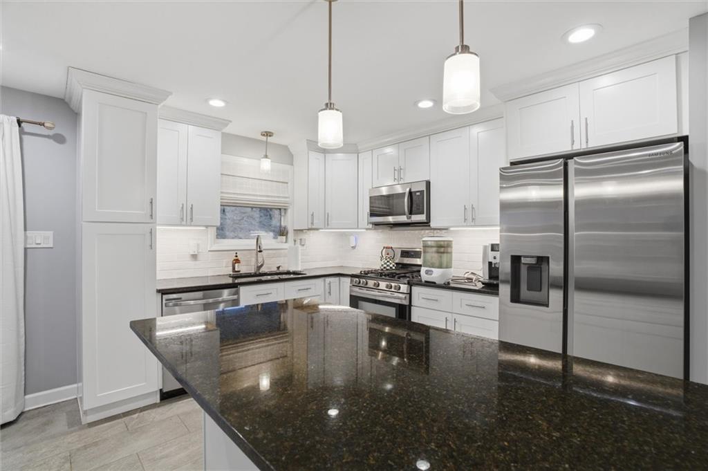 103 Tree View Drive Coraopolis, PA 15108 - Photo 16 of 48 a kitchen with a refrigerator a stove a oven and a sink with cabinets