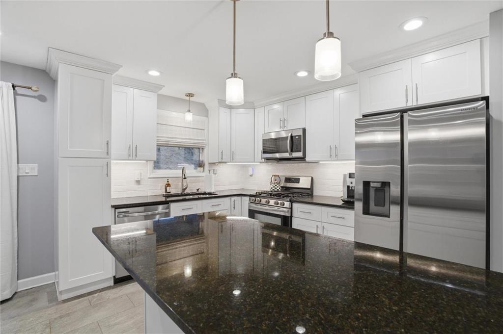 103 Tree View Drive Coraopolis, PA 15108 - Photo 17 of 48 a kitchen with kitchen island a large counter top appliances and cabinets