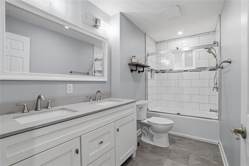 103 Tree View Drive Coraopolis, PA 15108 - Photo 22 of 48 a bathroom with a granite countertop sink a toilet and a mirror