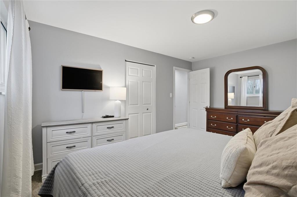 103 Tree View Drive Coraopolis, PA 15108 - Photo 25 of 48 a bedroom with a bed and a flat screen tv