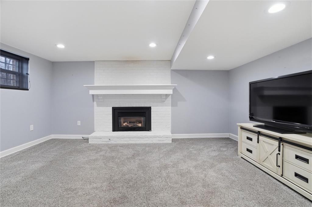 103 Tree View Drive Coraopolis, PA 15108 - Photo 35 of 48 a living room with furniture a flat screen tv and a fireplace