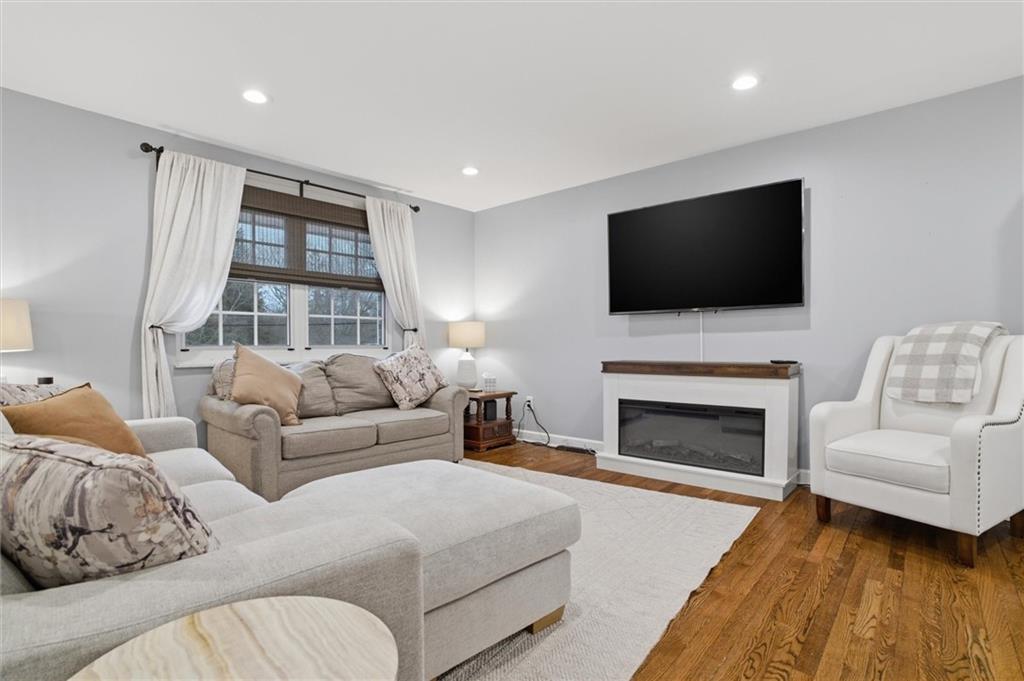 103 Tree View Drive Coraopolis, PA 15108 - Photo 8 of 48 a living room with furniture a fireplace and a flat screen tv