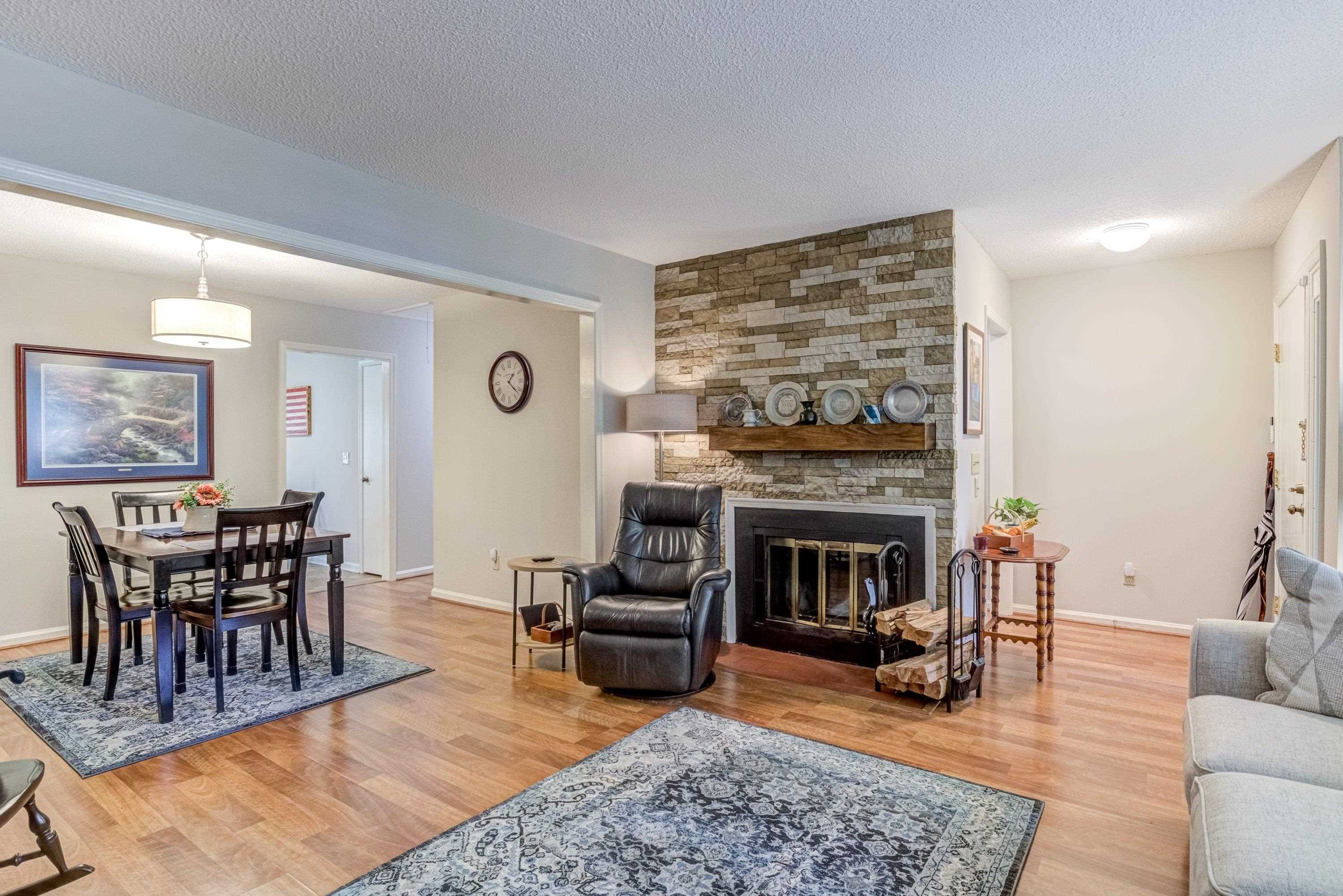 705 Tan Tara Square Raleigh, NC 27615 - Photo 11 of 31 a living room with furniture dining table and a fireplace