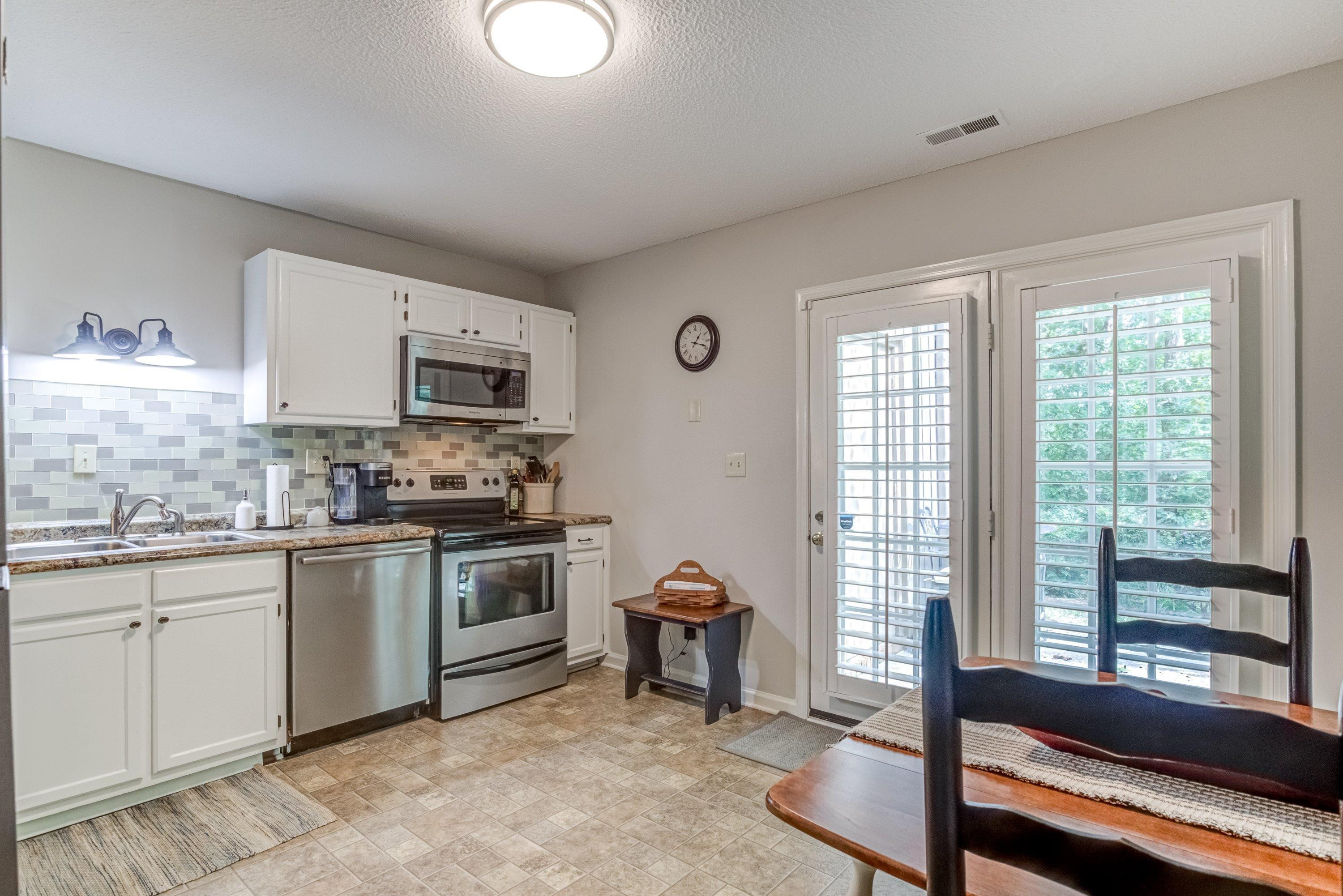 705 Tan Tara Square Raleigh, NC 27615 - Photo 14 of 31 a kitchen with a sink cabinets and window