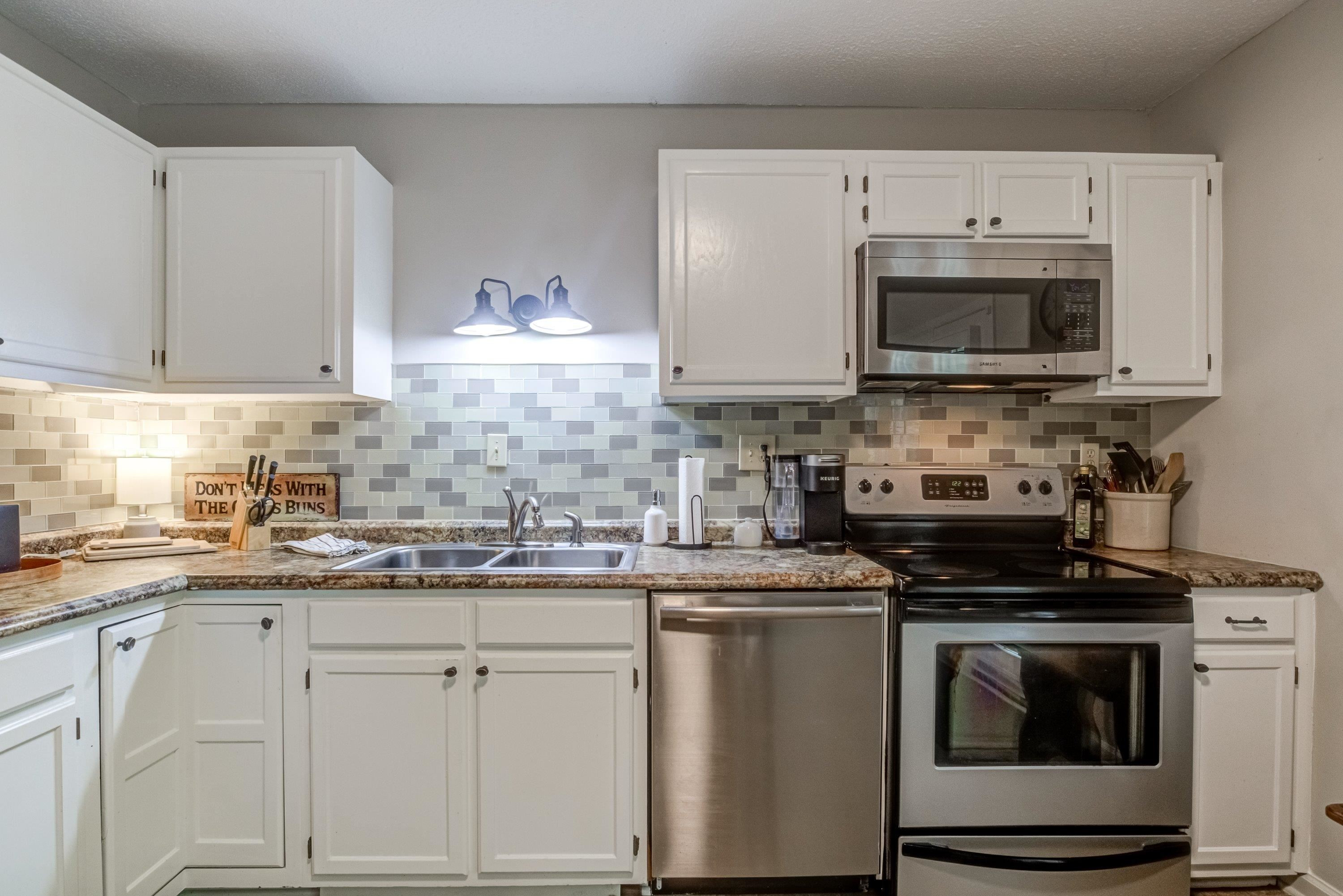 705 Tan Tara Square Raleigh, NC 27615 - Photo 16 of 31 a kitchen with stainless steel appliances granite countertop a sink stove and microwave