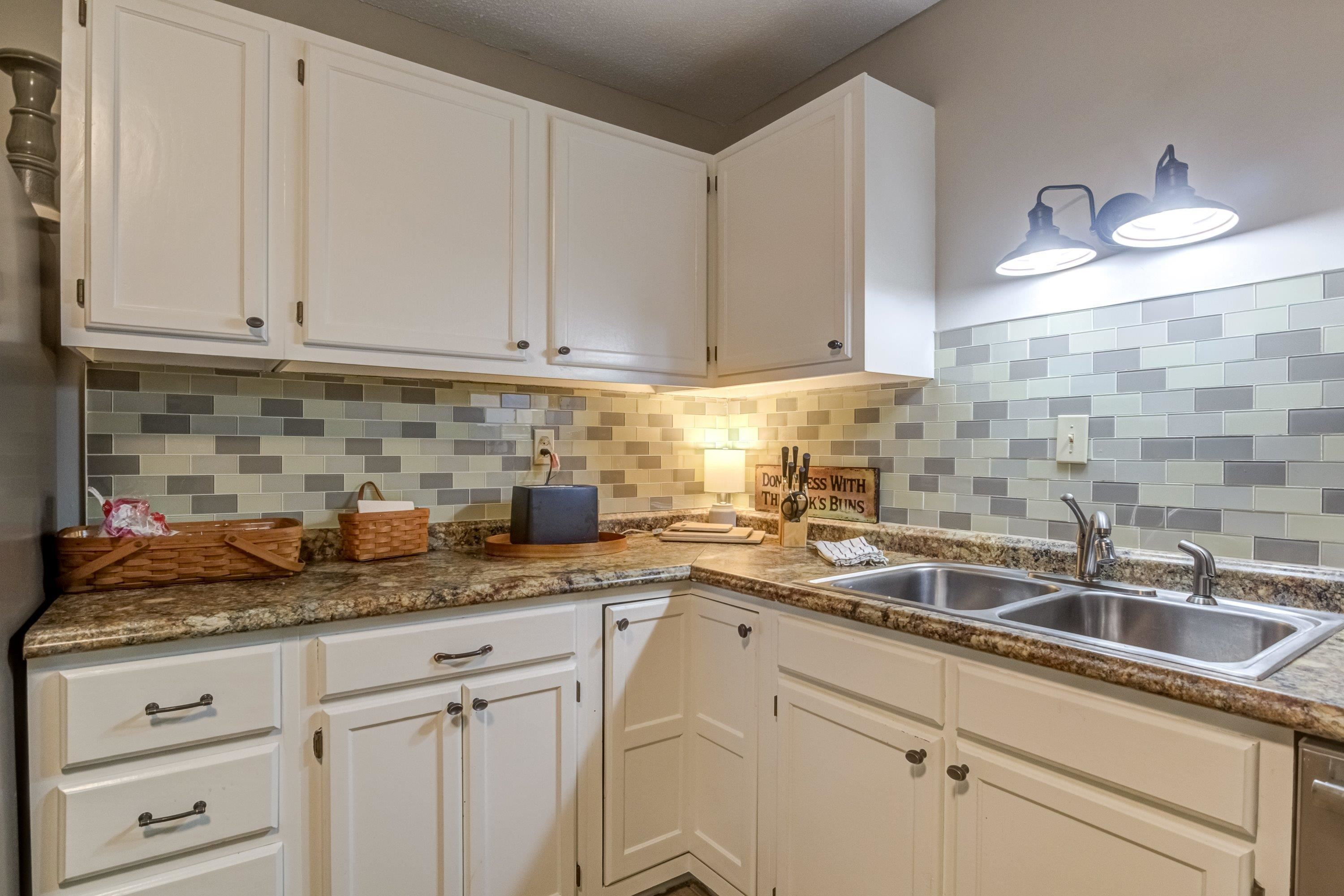 705 Tan Tara Square Raleigh, NC 27615 - Photo 19 of 31 a kitchen with granite countertop a sink and cabinets