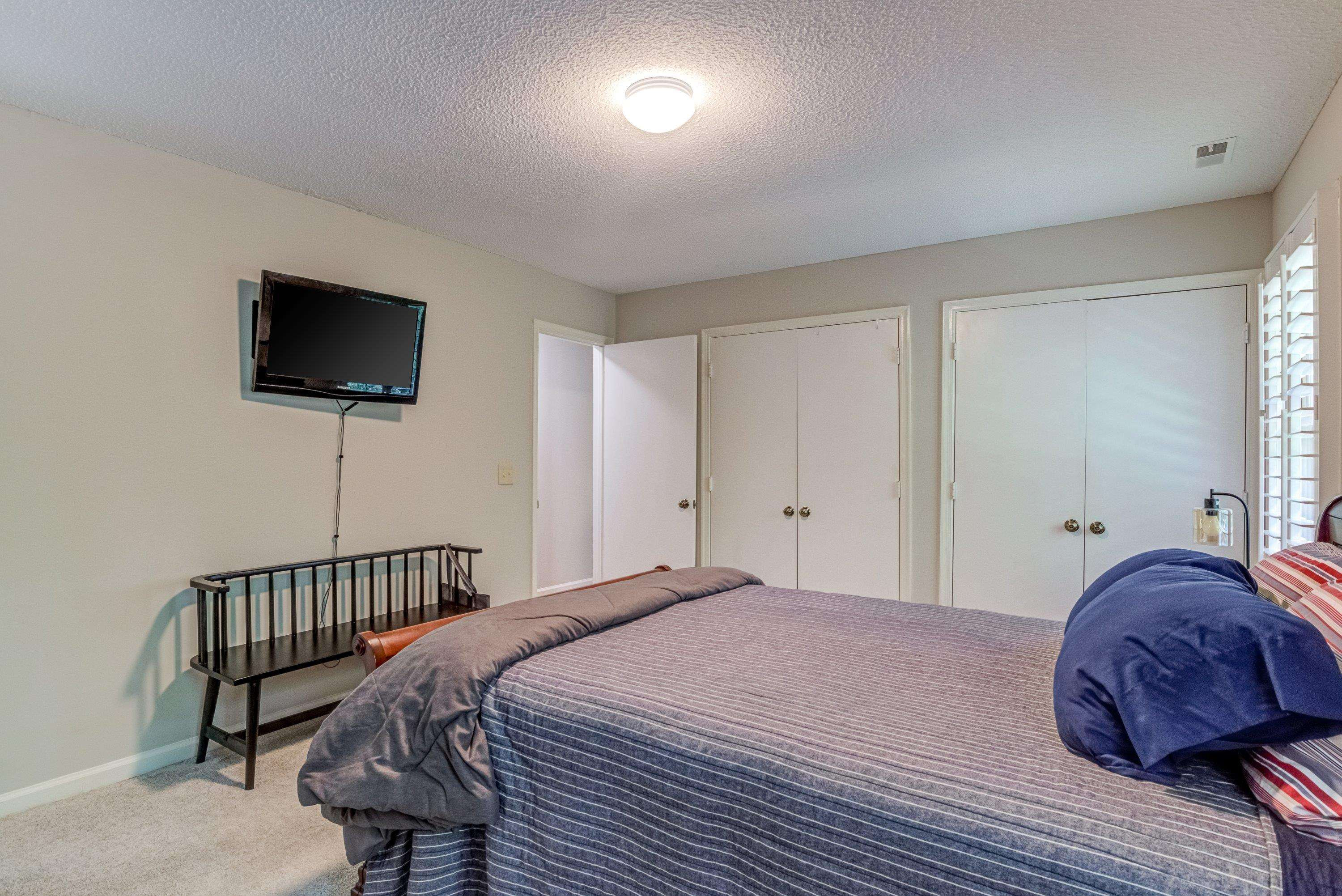 705 Tan Tara Square Raleigh, NC 27615 - Photo 21 of 31 a bedroom with a bed a flat tv screen and dresser