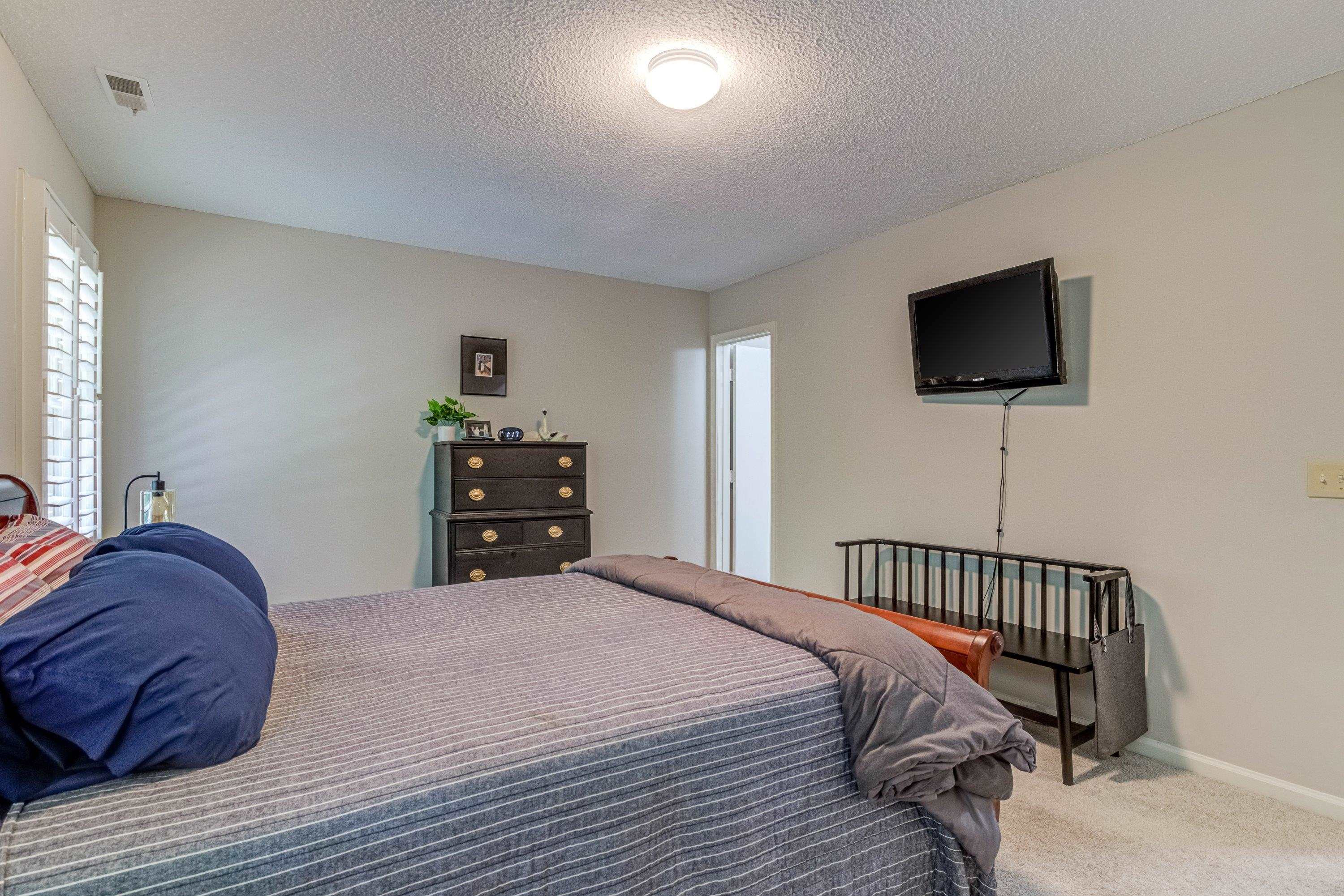 705 Tan Tara Square Raleigh, NC 27615 - Photo 22 of 31 a bedroom with a bed and a flat screen tv