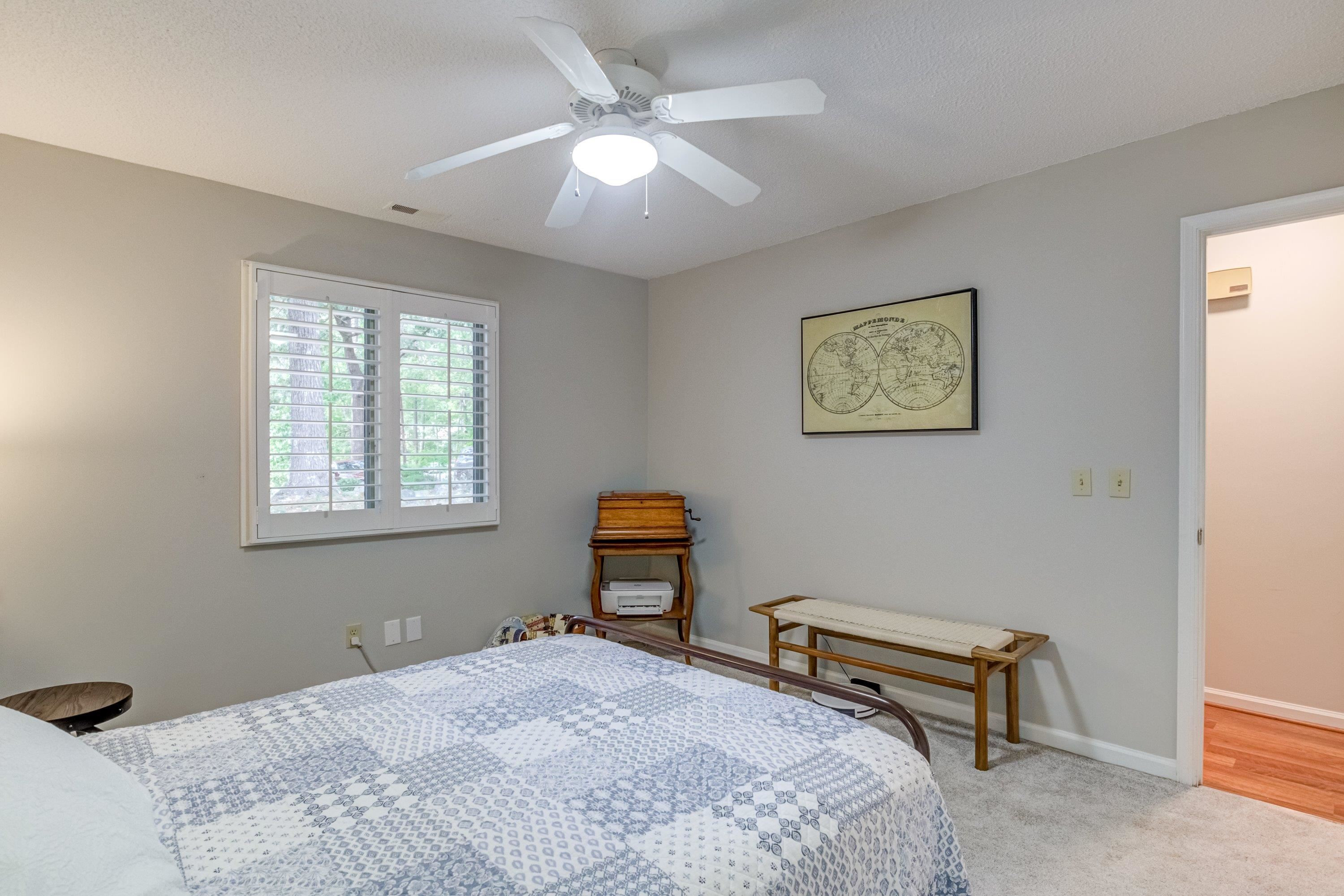 705 Tan Tara Square Raleigh, NC 27615 - Photo 24 of 31 a bedroom with a bed and a chandelier
