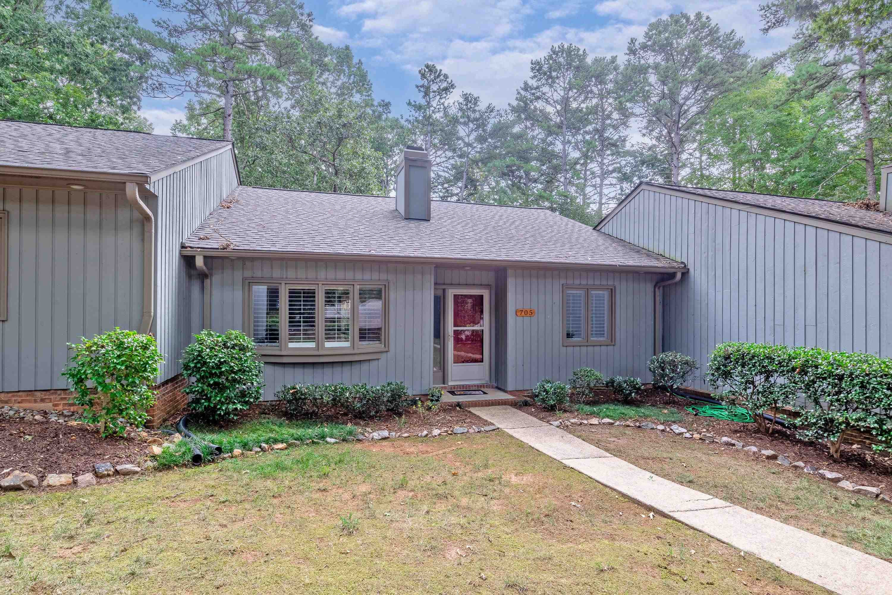 705 Tan Tara Square Raleigh, NC 27615 - Photo 4 of 31 a front view of a house with a yard and a garden
