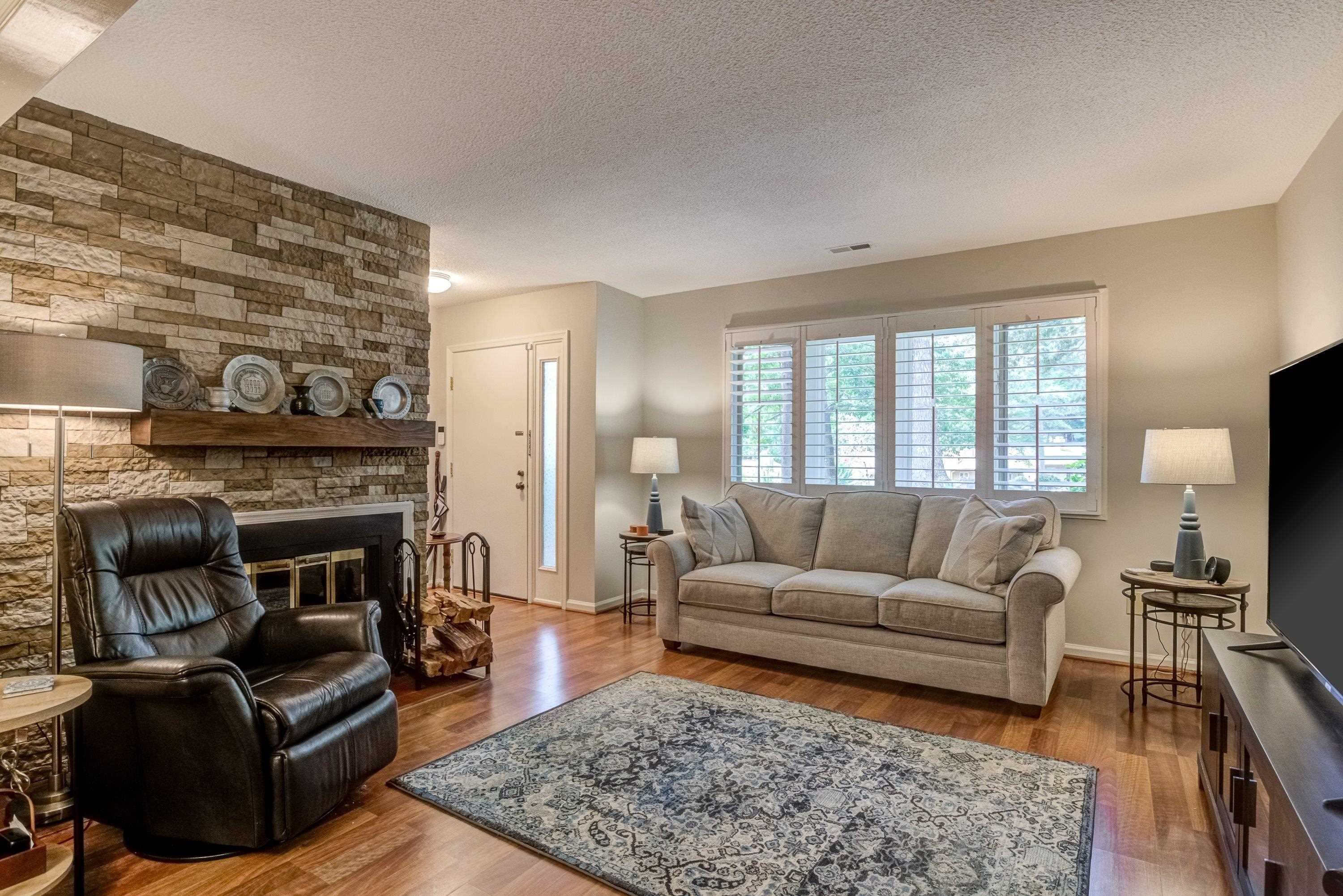 705 Tan Tara Square Raleigh, NC 27615 - Photo 8 of 31 a living room with furniture and a fireplace