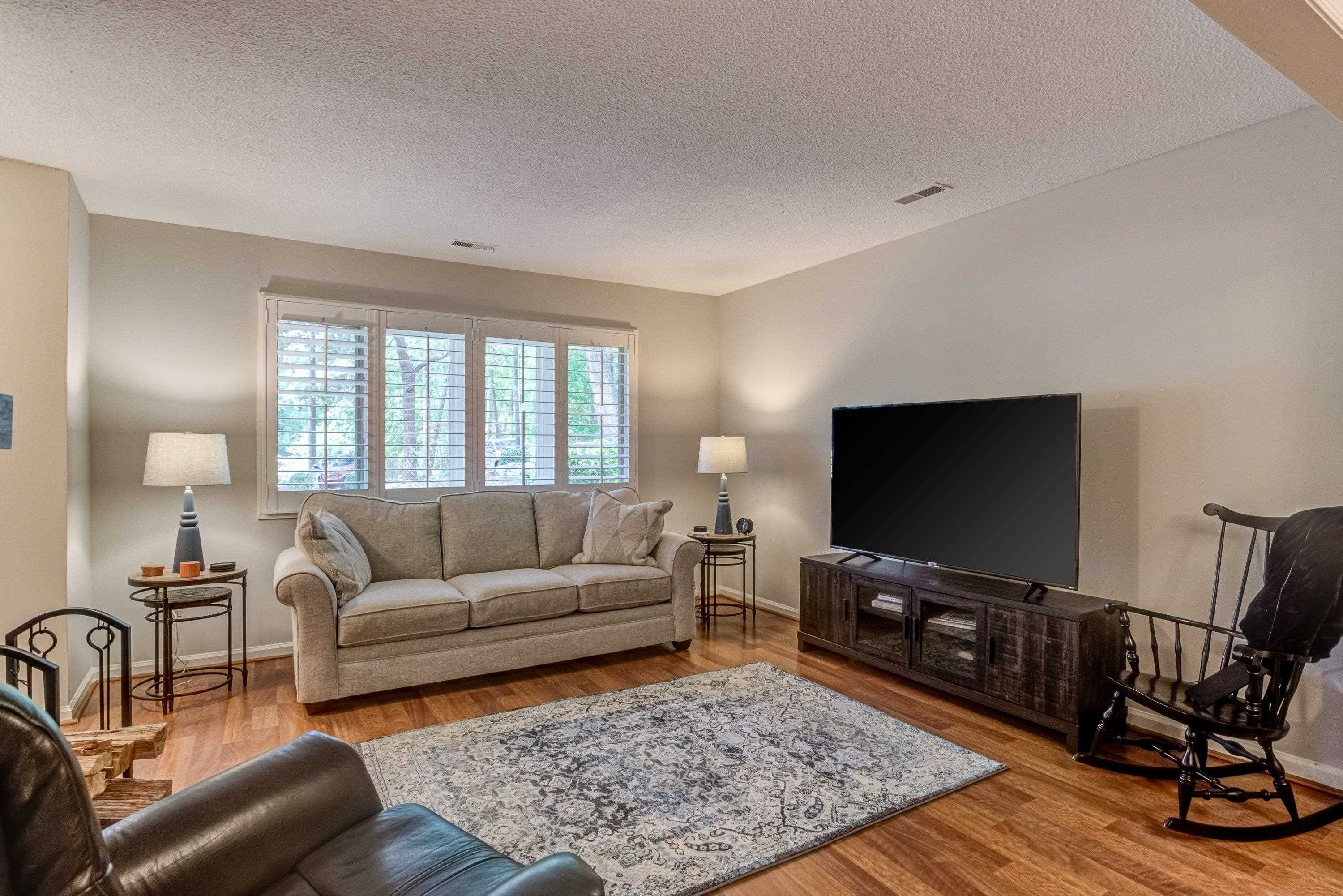 705 Tan Tara Square Raleigh, NC 27615 - Photo 9 of 31 a living room with furniture and a flat screen tv