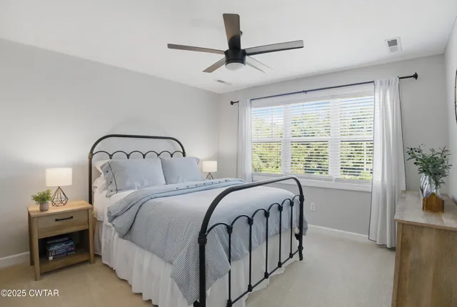 a bedroom with a bed next to a window