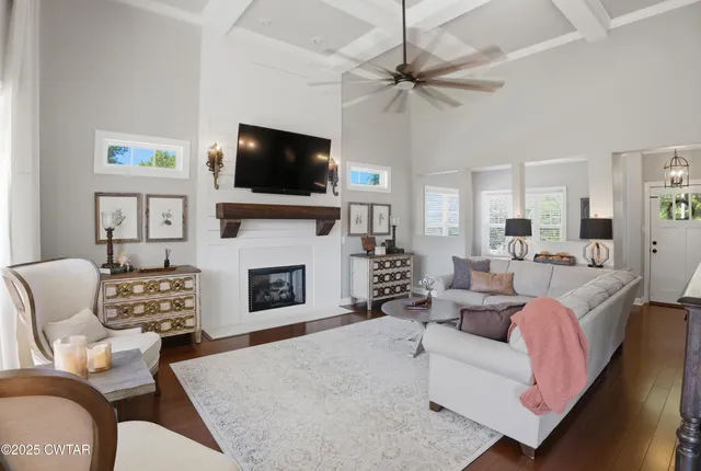 a living room with furniture a fireplace and a flat screen tv