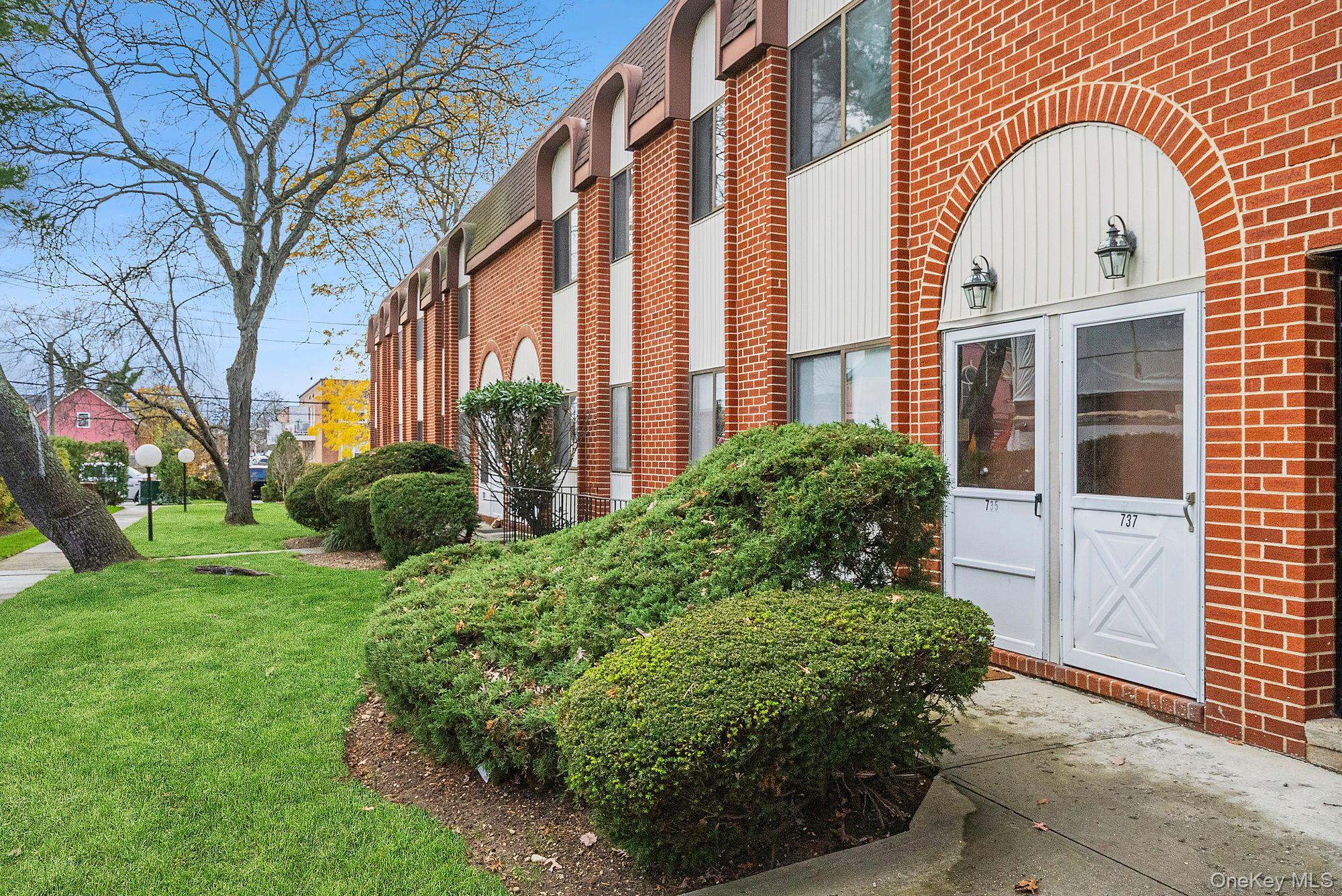 659 Chestnut Street Cedarhurst, NY 11516 - Photo 1 of 1 a view of a brick house with a large windows