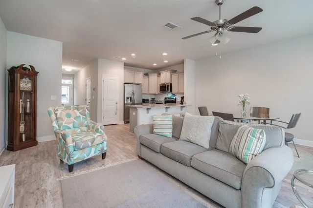 a living room with furniture and a chandelier