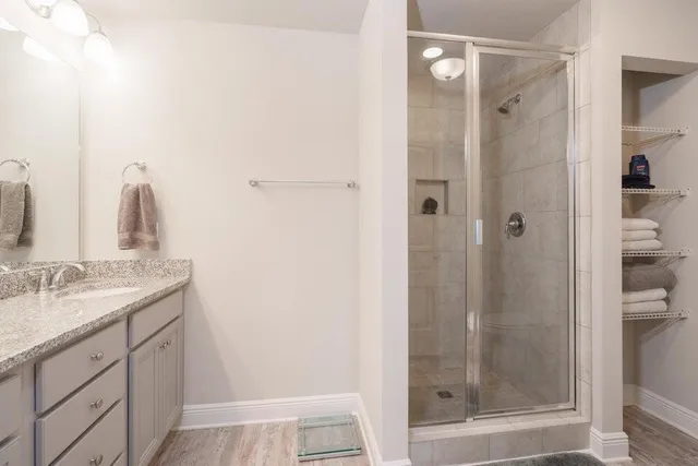 a bathroom with a shower sink and mirror