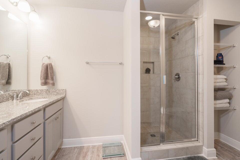 90 Crossing Lane, Unit B Santa Rosa Beach, FL 32459 - Photo 15 of 23 a bathroom with a shower sink and mirror