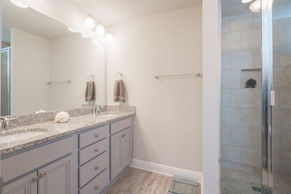 90 Crossing Lane, Unit B Santa Rosa Beach, FL 32459 - Photo 16 of 23 a bathroom with a granite countertop sink a mirror and a shower