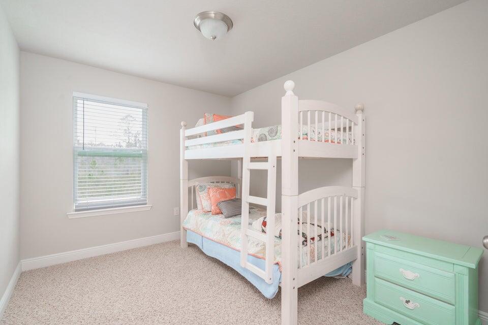 90 Crossing Lane, Unit B Santa Rosa Beach, FL 32459 - Photo 18 of 23 a view of a bedroom with baby bed