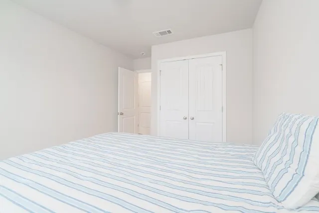 a large white bed in a white room
