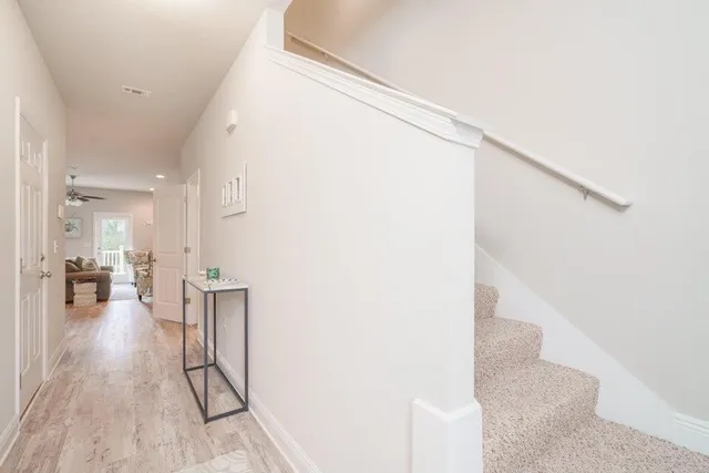 a view of entryway and hall with wooden floor