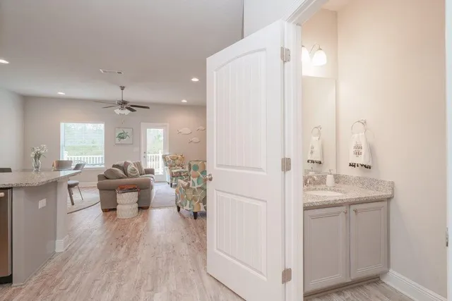 a living room with furniture and view of kitchen appliances