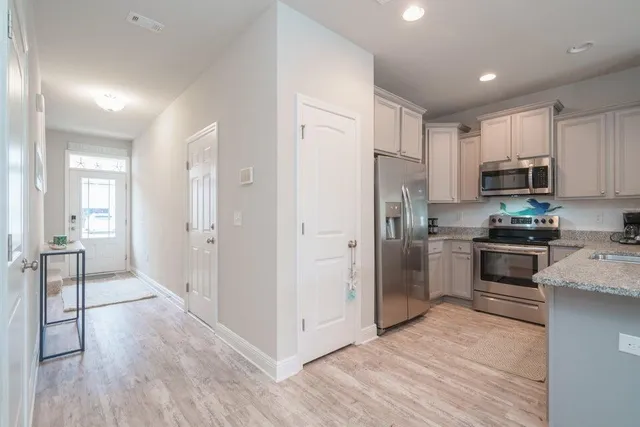 a kitchen with stainless steel appliances a refrigerator and a stove top oven