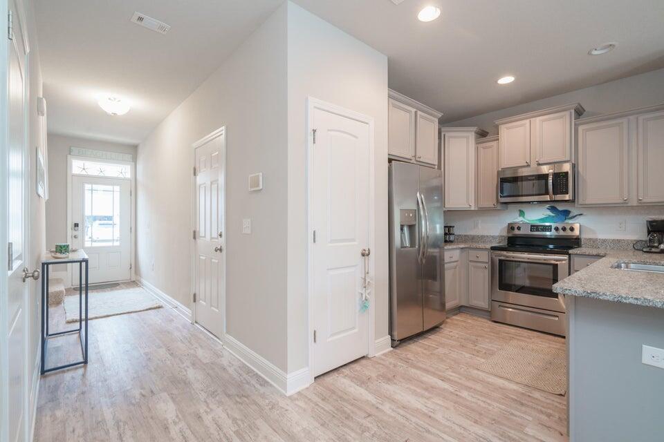 90 Crossing Lane, Unit B Santa Rosa Beach, FL 32459 - Photo 6 of 23 a kitchen with stainless steel appliances a refrigerator and a stove top oven