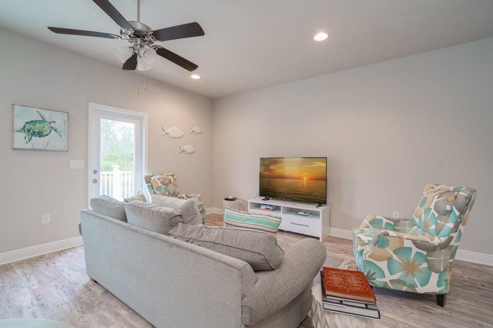 90 Crossing Lane, Unit B Santa Rosa Beach, FL 32459 - Photo 8 of 23 a living room with furniture and a flat screen tv