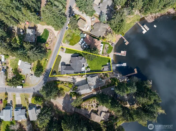 an aerial view of a house with a yard