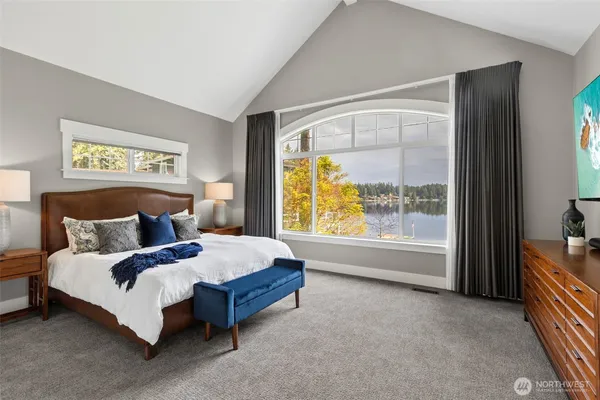 a bed sitting in a bedroom next to a window