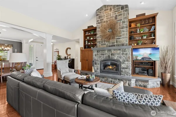 a living room with furniture a fireplace and a rug