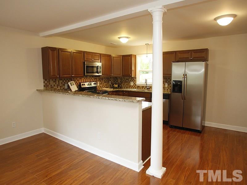606 Frank Street Raleigh, NC 27604 - Photo 3 of 25 a kitchen with stainless steel appliances a refrigerator sink and microwave