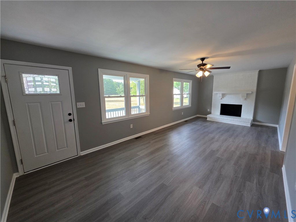 7613 Squirrel Level Road Petersburg, VA 23805 - Photo 13 of 30 LVP flooring throughout, white-painted brick firep