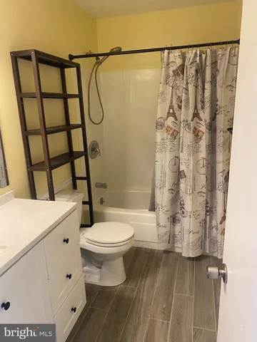 a bathroom with a toilet sink and shower