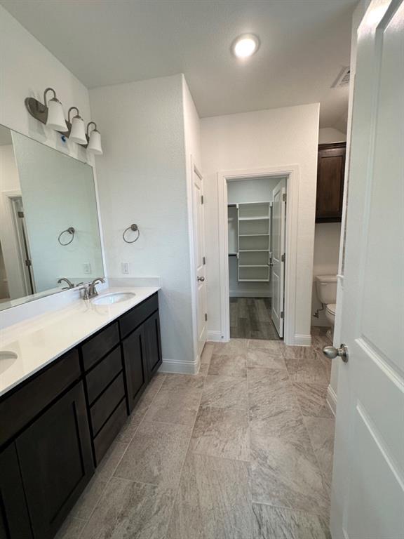 418 South 2nd Street Krum, TX 76249 - Photo 13 of 17 a bathroom with a double vanity sink and a mirror